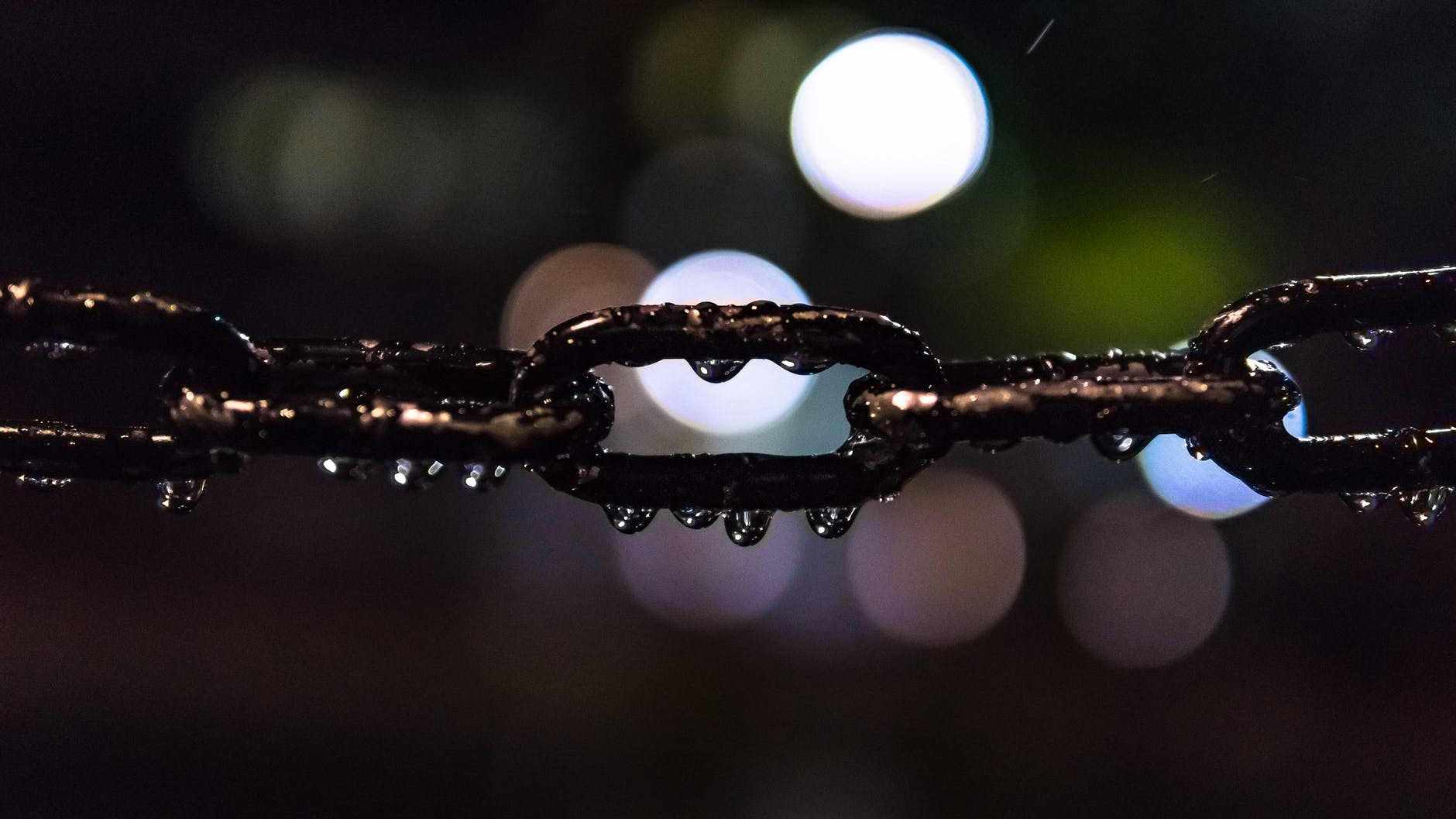 selective focus photo of black metal chain